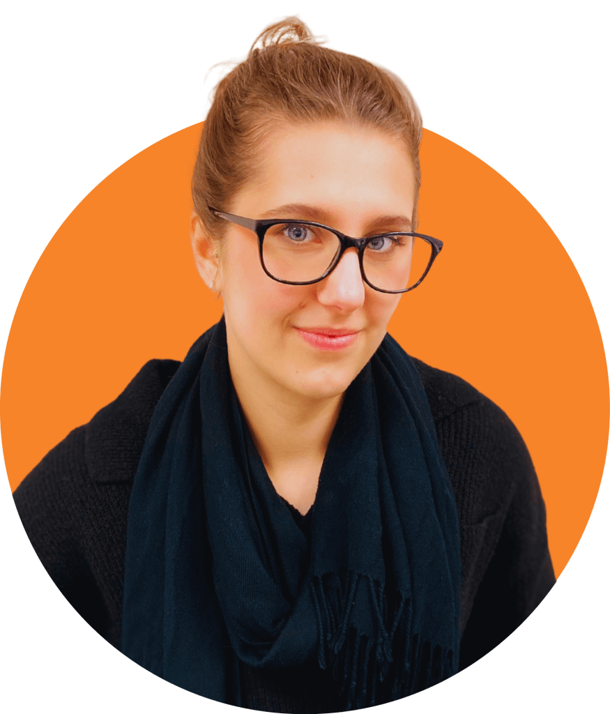 Gabby Solarek trainee account manager wearing glasses and black scarf in front of a orange circle