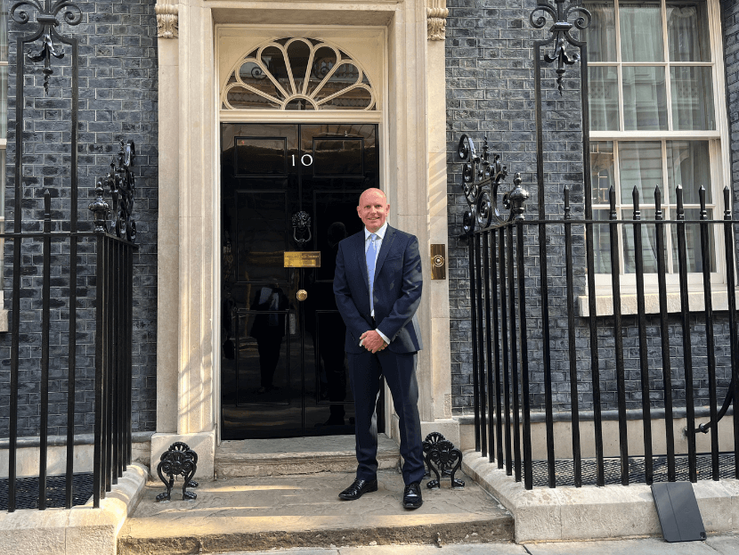Lance Hill standing in front of the front door of Number 10 Downing Street